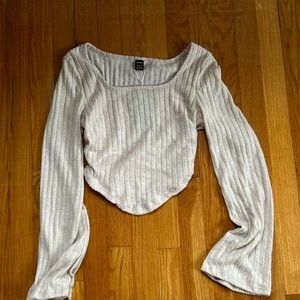 Cream tan top that is shorter in back and longer v in front